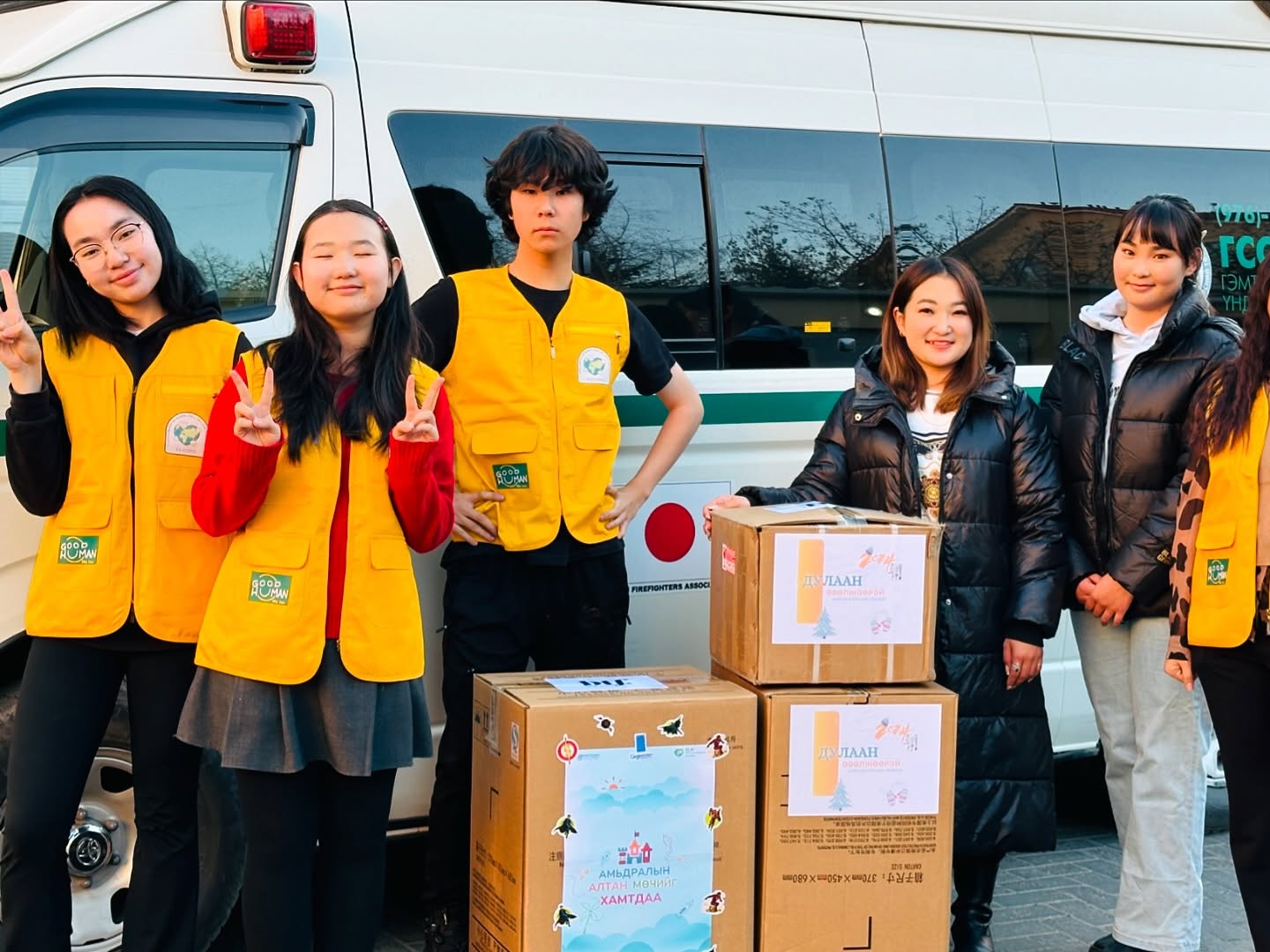 Youth volunteers delivering donation boxes together