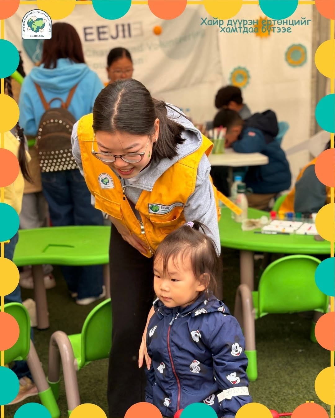 EEJII volunteer bonding with a child at an outreach event